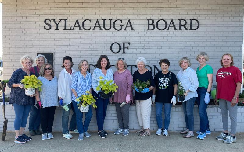 Magnolia Garden Club plants flowers in front of Sylacauga Board of Education