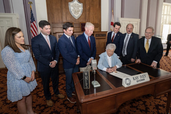 With Gov. Ivey: Claire Hodges, Michael Brannon, Jeremy Law, Lee Perryman, Representative Ben Robbins, Senator Keith Kelley, Curtis O. Liles III